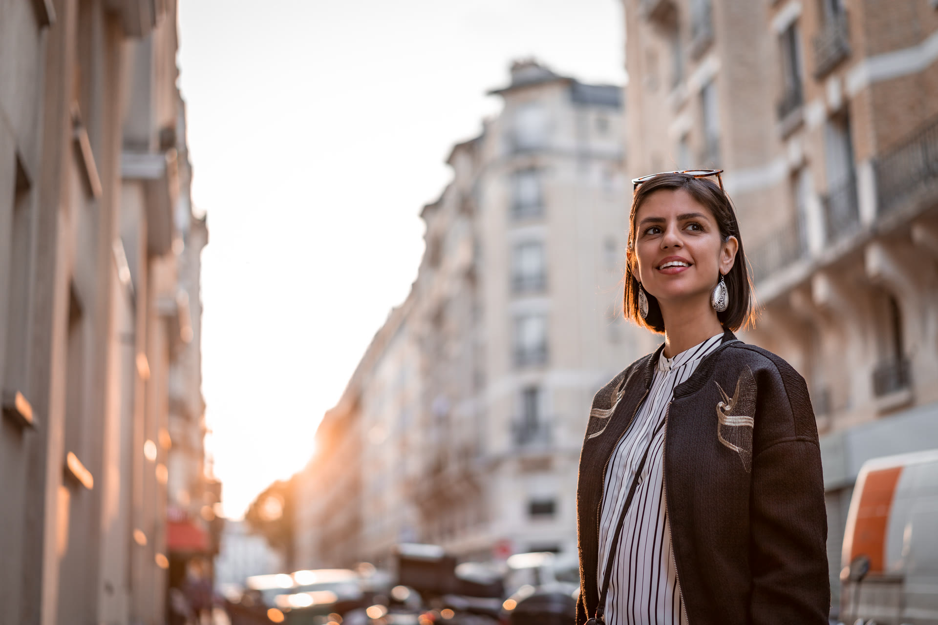 A woman exploring a sunlit city street