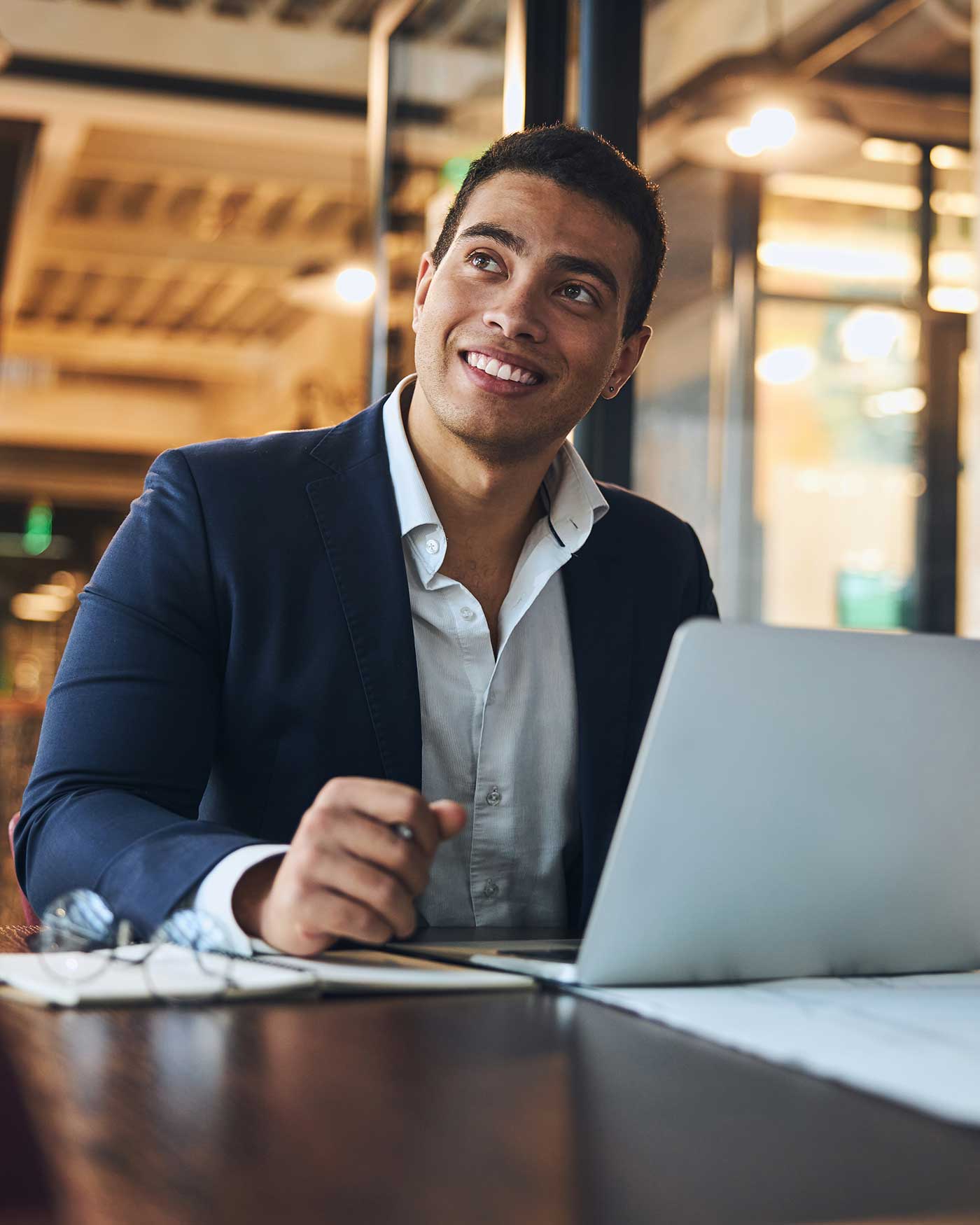 A business professional working on a laptop in an office